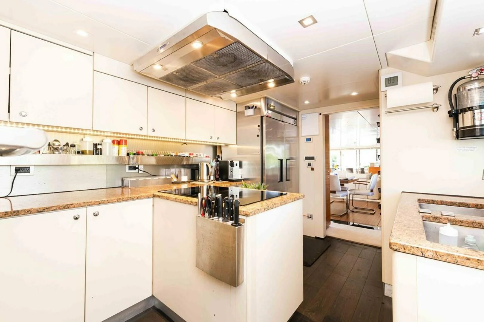 a kitchen with white cabinets aboard SEA AXIS Yacht for Charter