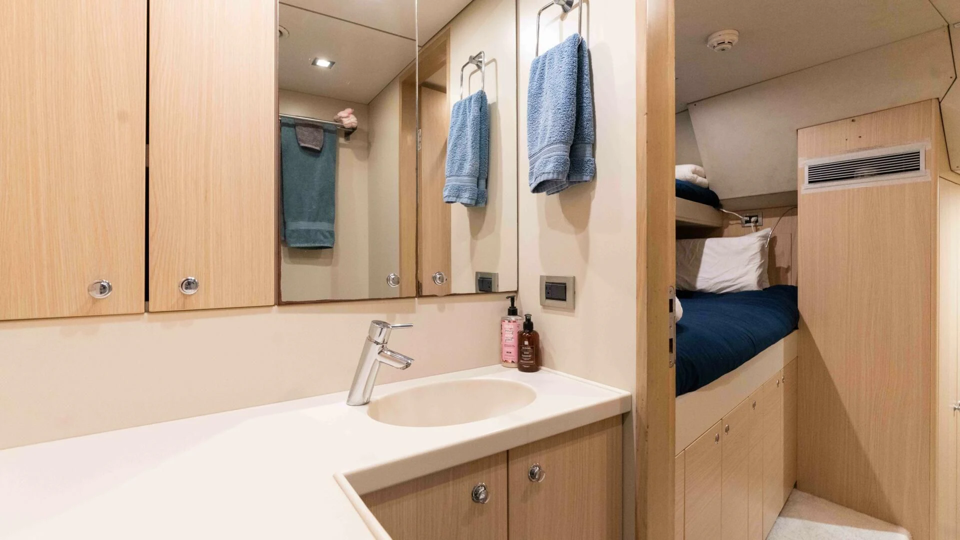 a bathroom with a sink and a mirror aboard SEA AXIS Yacht for Charter