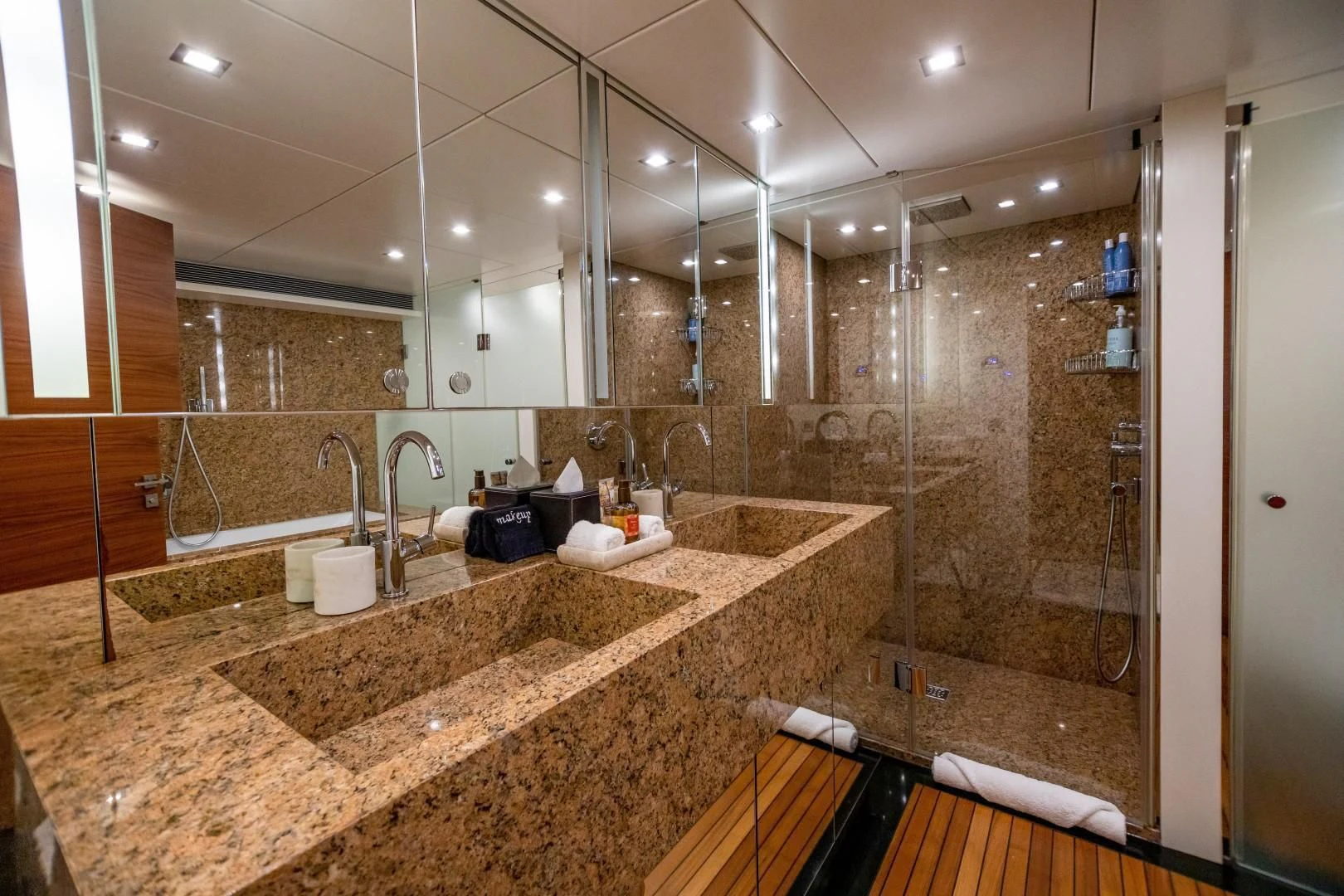 a bathroom with a countertop sink and a large mirror aboard SEA AXIS Yacht for Charter
