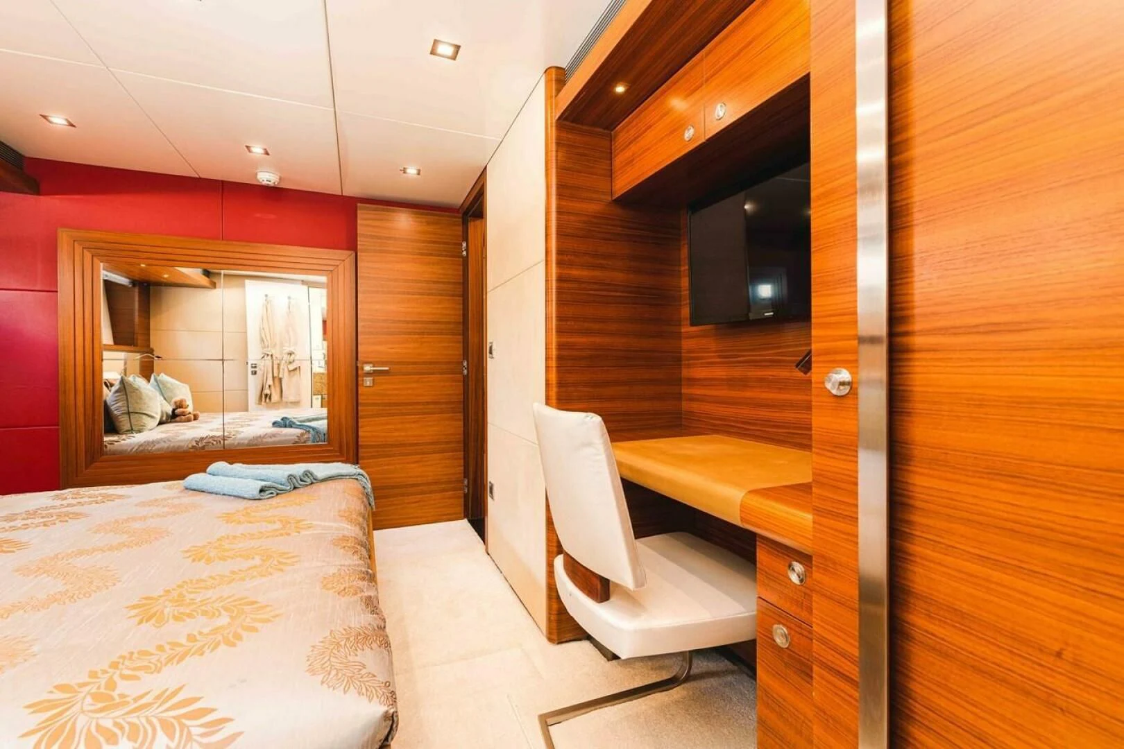 a room with a bed and a chair aboard SEA AXIS Yacht for Charter