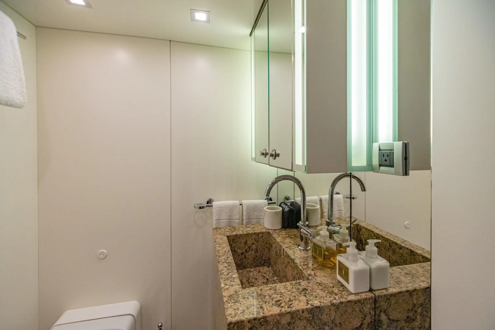 a bathroom with a countertop sink and mirror aboard SEA AXIS Yacht for Charter