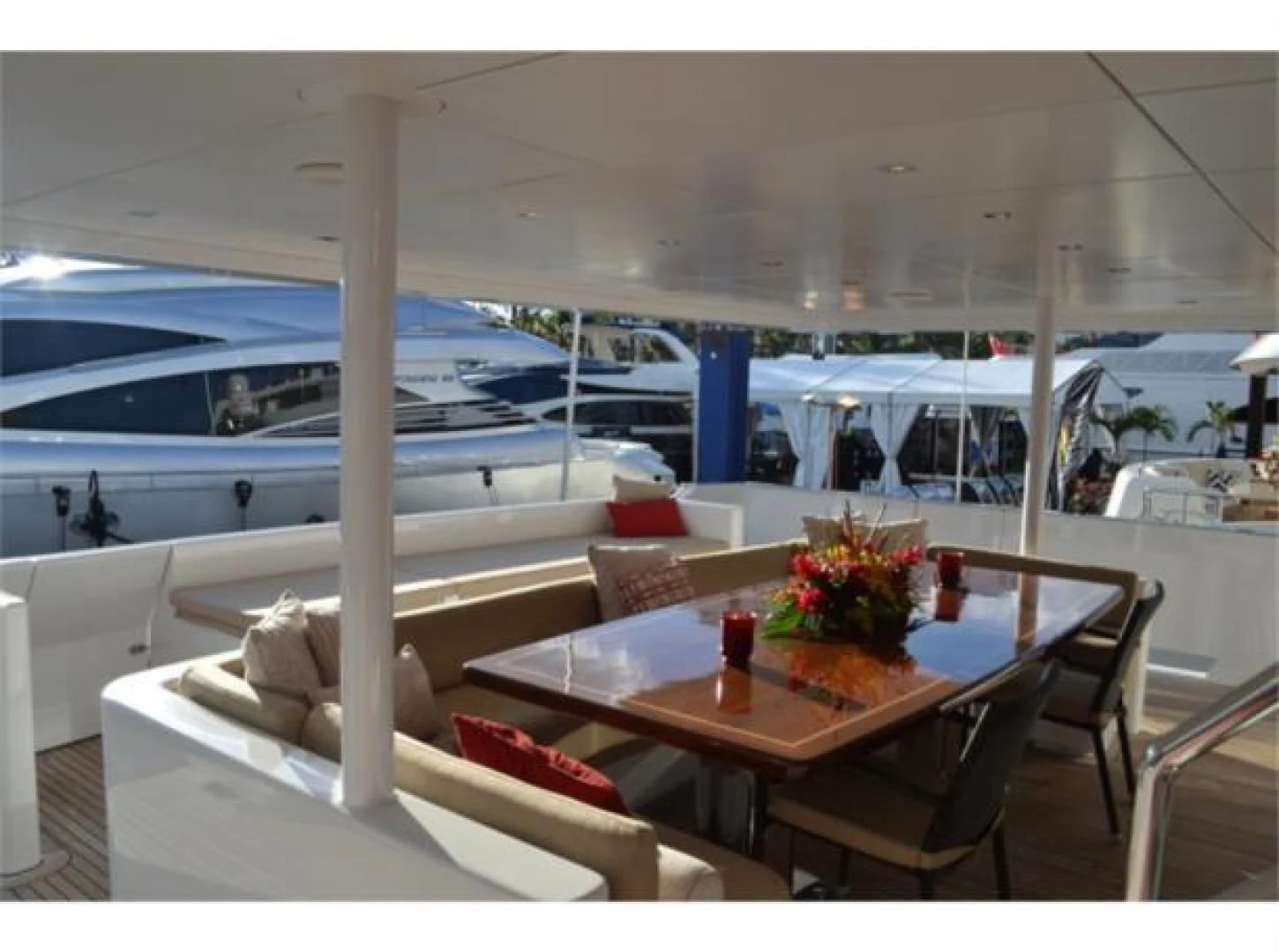 a table with chairs and a glass window aboard SEA AXIS Yacht for Charter
