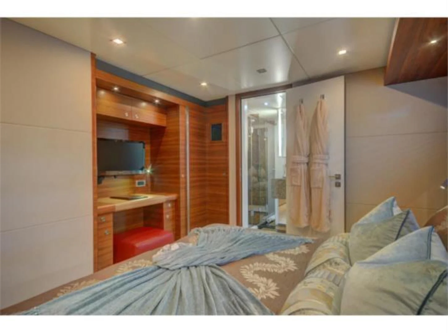 a bedroom with a bed and a desk aboard SEA AXIS Yacht for Charter