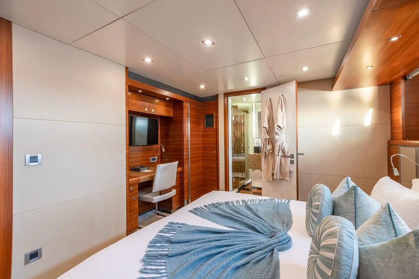 a bedroom with a bed and a desk aboard SEA AXIS Yacht for Charter