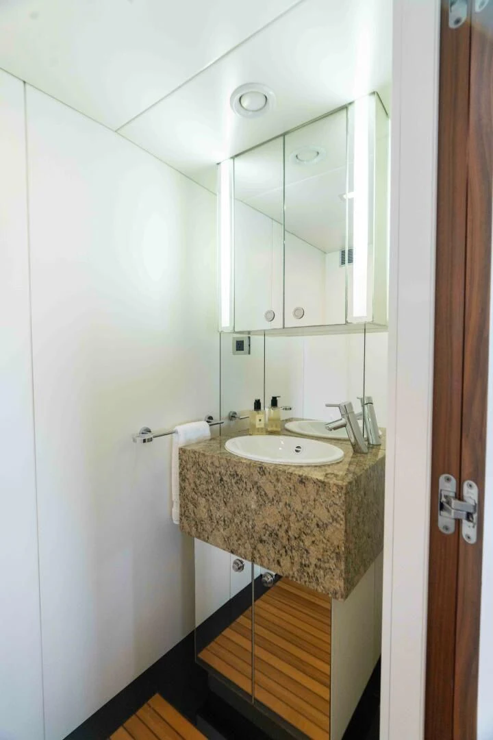 a bathroom with a sink and mirror aboard SEA AXIS Yacht for Charter