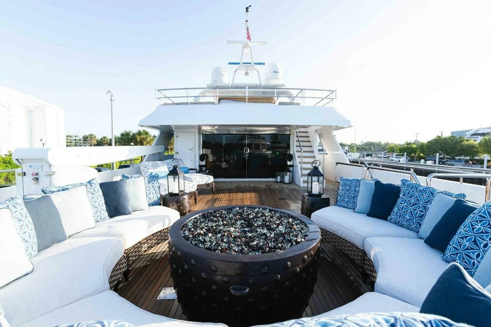 a large outdoor patio with a large round table and chairs aboard SEA AXIS Yacht for Charter