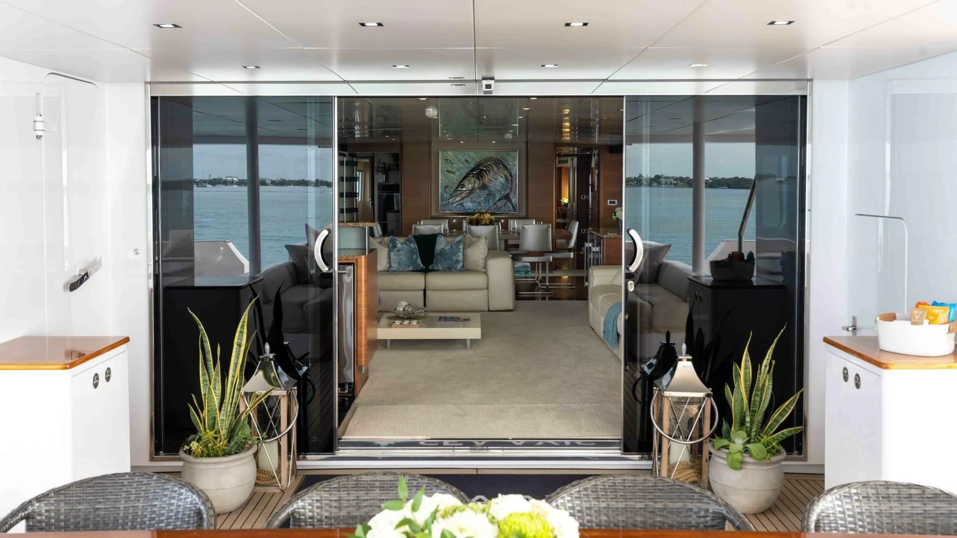a living room with a glass door aboard SEA AXIS Yacht for Charter