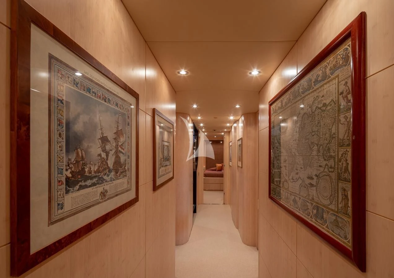 a hallway with art on the wall aboard GLAROS Yacht for Sale