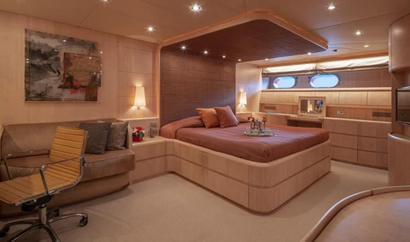 a bed and a chair in a room aboard GLAROS Yacht for Sale