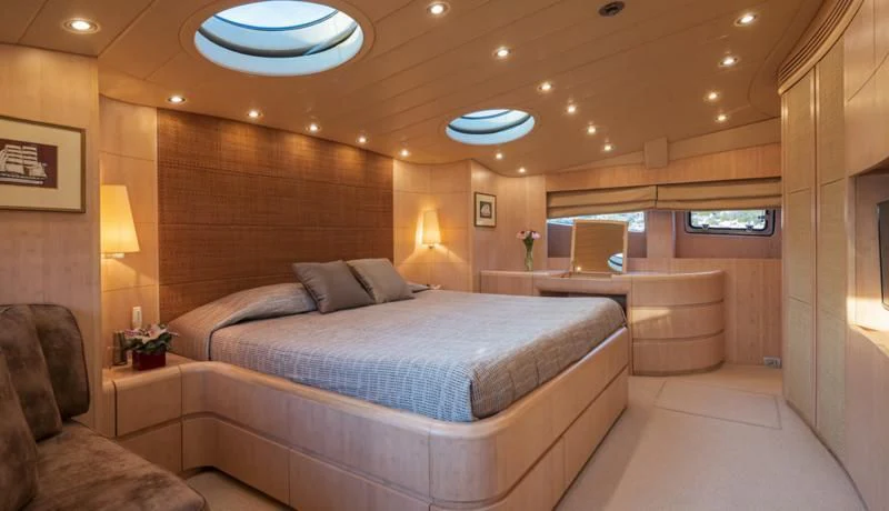 a large bed in a room aboard GLAROS Yacht for Sale