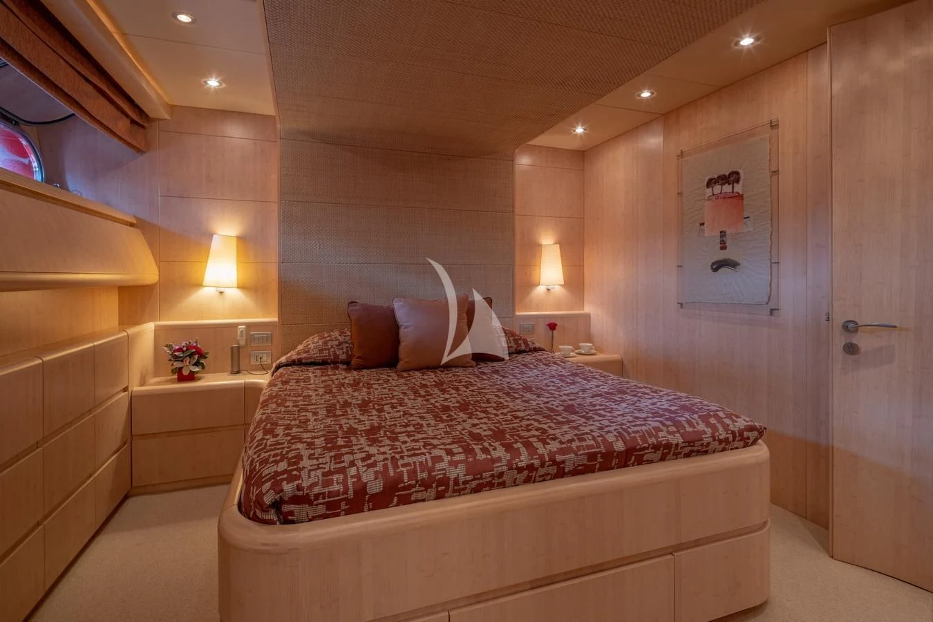 a bed with a red and white comforter and pillows aboard GLAROS Yacht for Sale