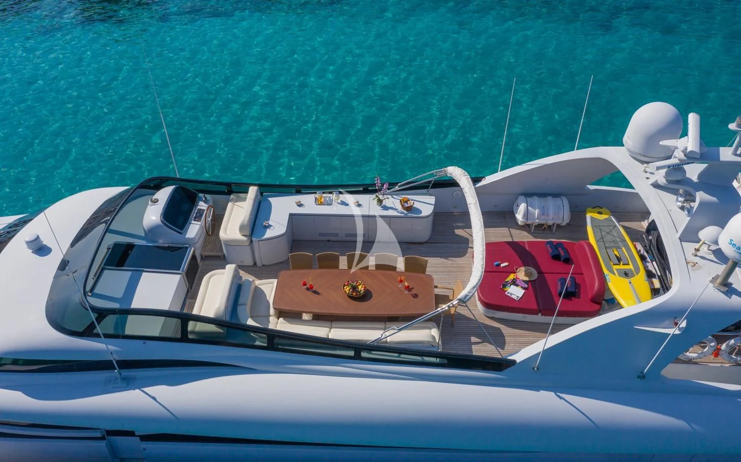 a white boat with a red stripe on the front aboard GLAROS Yacht for Sale