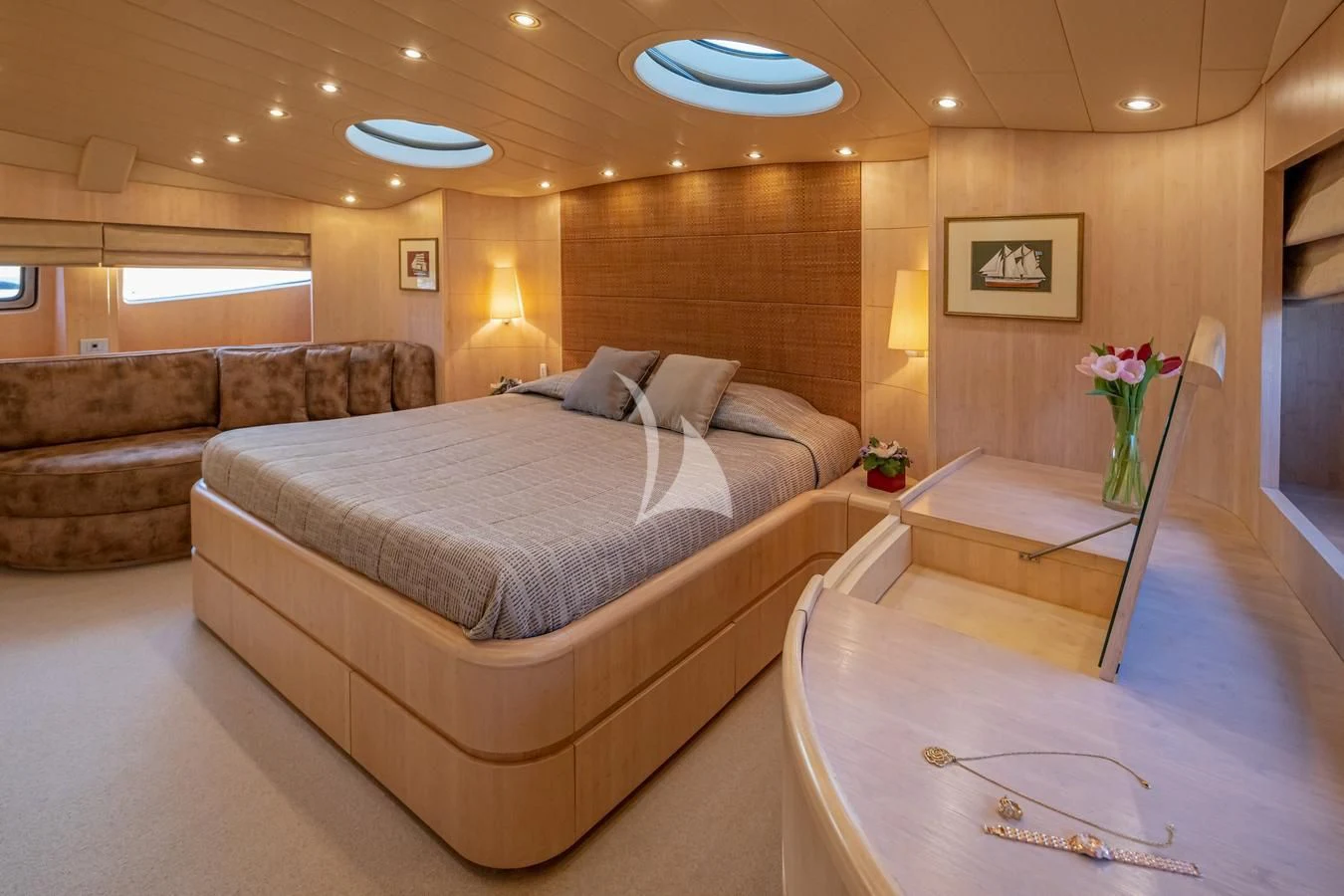 a large bedroom with a bed and a couch aboard GLAROS Yacht for Sale