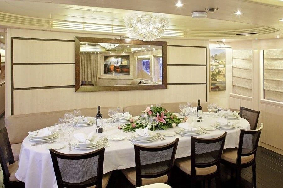 a dining room table set for a dinner party aboard GLAROS Yacht for Sale