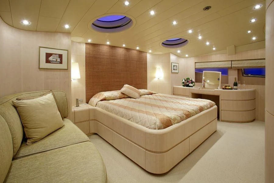 a room with a bed and a couch aboard GLAROS Yacht for Sale