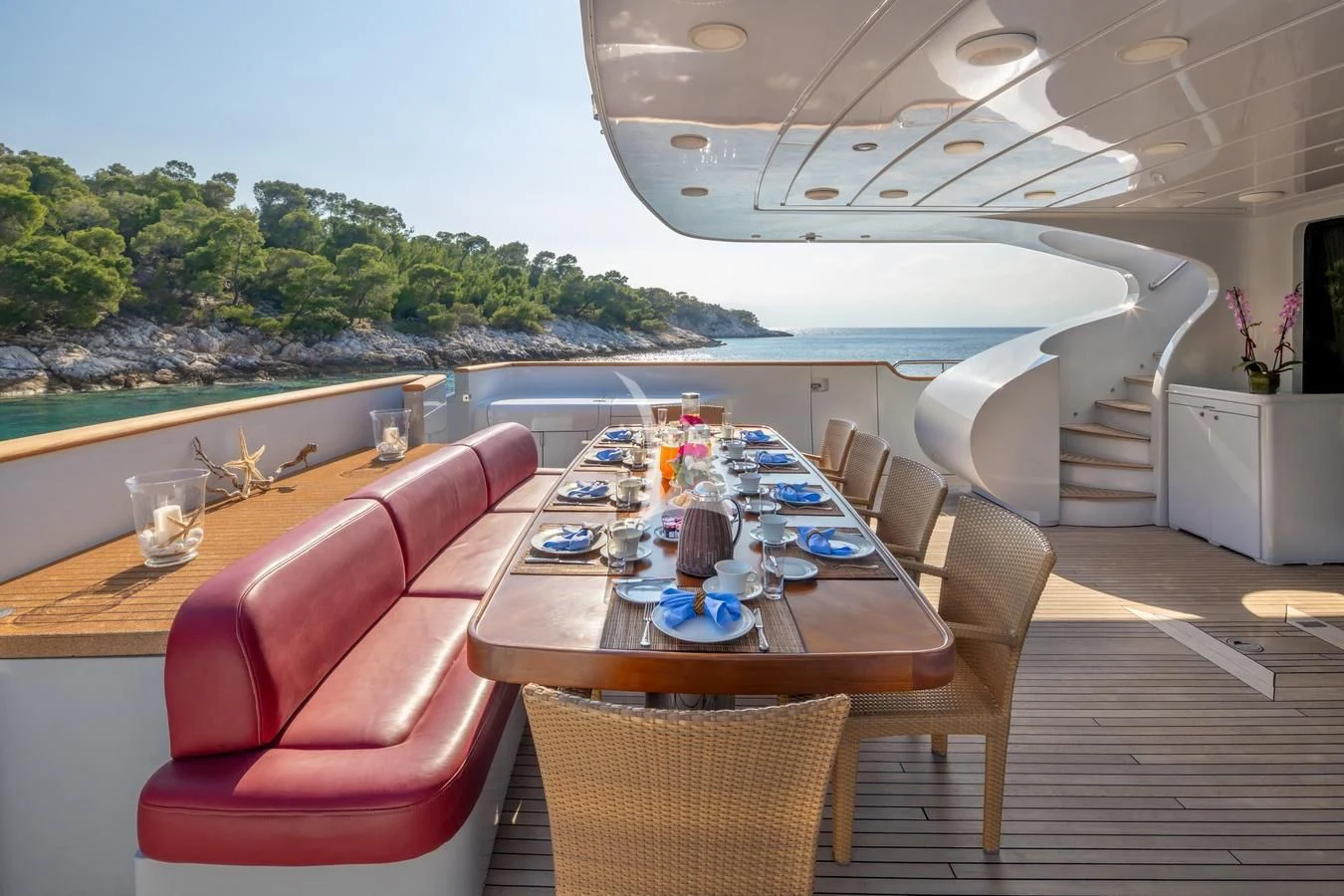 a dining table on a deck aboard GLAROS Yacht for Sale