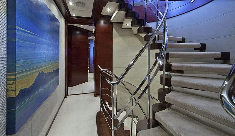 a staircase with a blue wall aboard SARAH Yacht for Sale