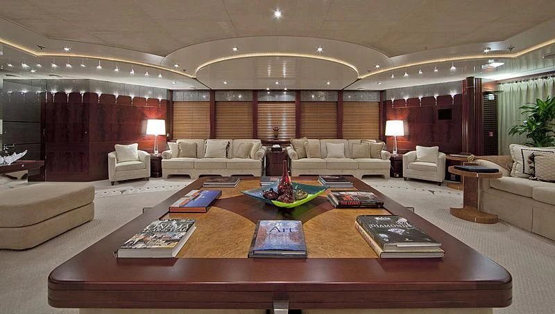 a large living room with a large table and couches aboard SARAH Yacht for Sale