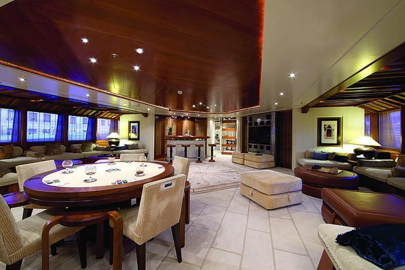 a large living room with a table and chairs aboard SARAH Yacht for Sale