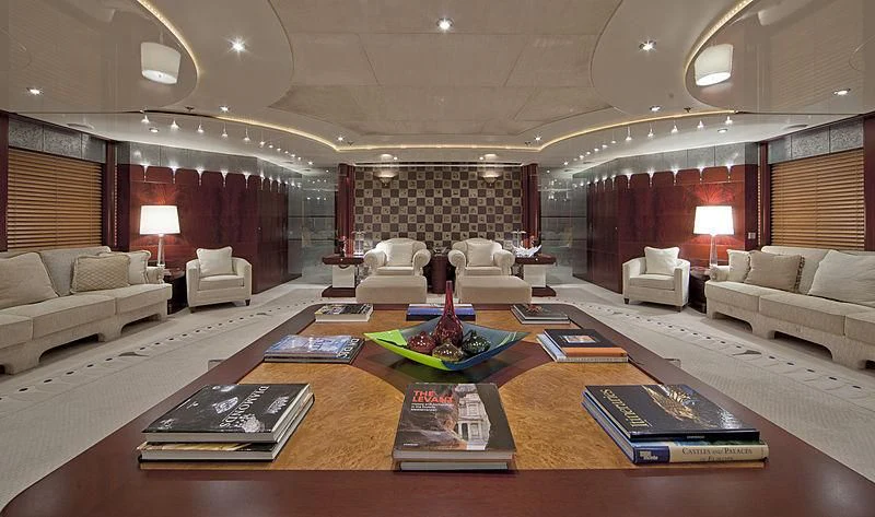 a living room with a table and couches aboard SARAH Yacht for Sale