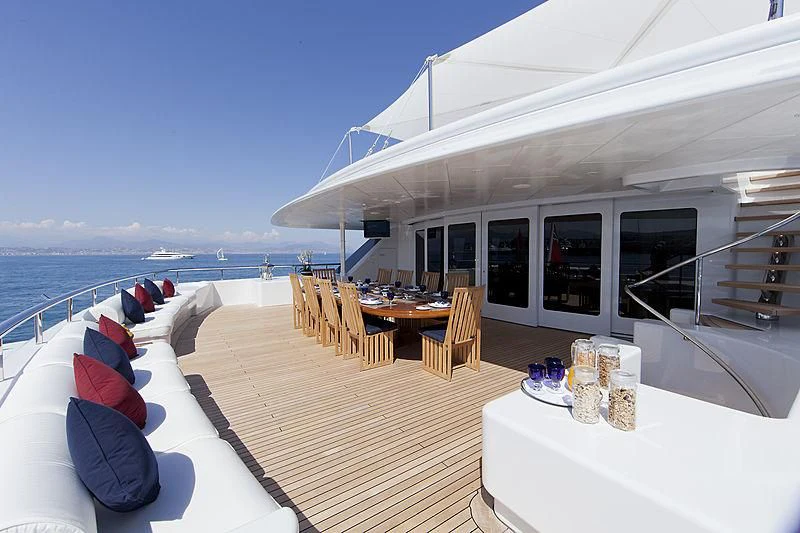a deck with a table and chairs on it aboard SARAH Yacht for Sale