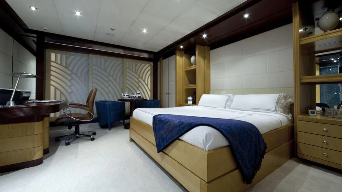 a bedroom with a bed and desk aboard SARAH Yacht for Sale