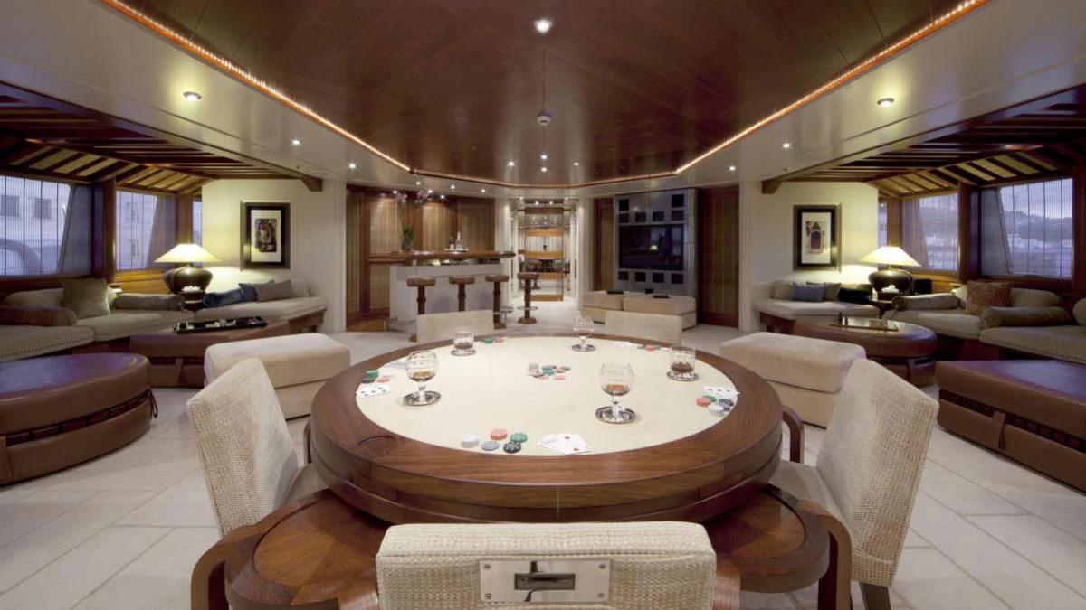 a large living room with a large round table aboard SARAH Yacht for Sale