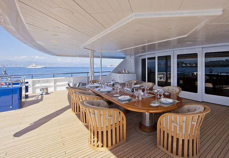 a large dining table on a deck aboard SARAH Yacht for Sale