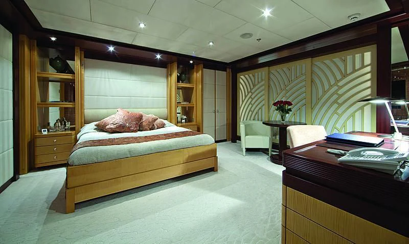 a bedroom with a bed and desk aboard SARAH Yacht for Sale