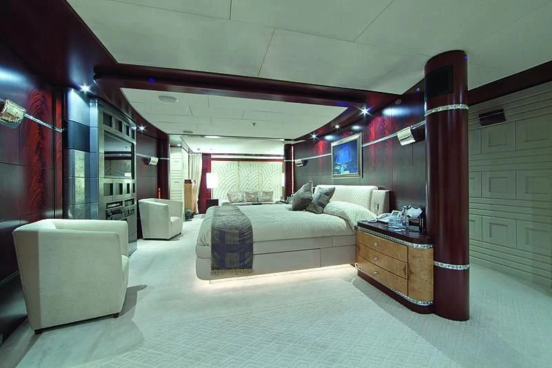a bedroom with a bed and a chair aboard SARAH Yacht for Sale