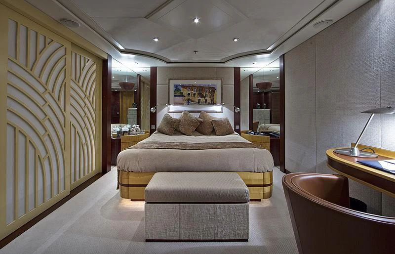 a bedroom with a bed and a desk aboard SARAH Yacht for Sale