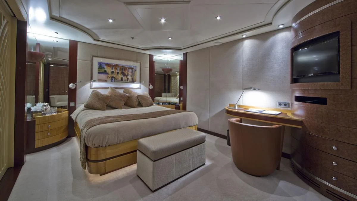 a bedroom with a bed and a tv aboard SARAH Yacht for Sale