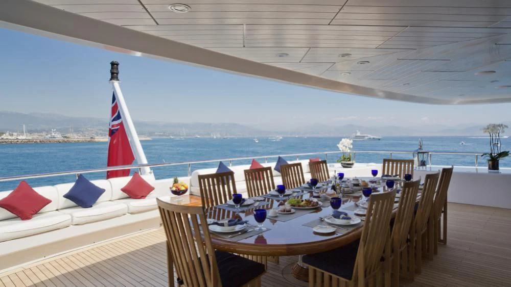 a table set for a meal on a deck overlooking the ocean aboard SARAH Yacht for Sale