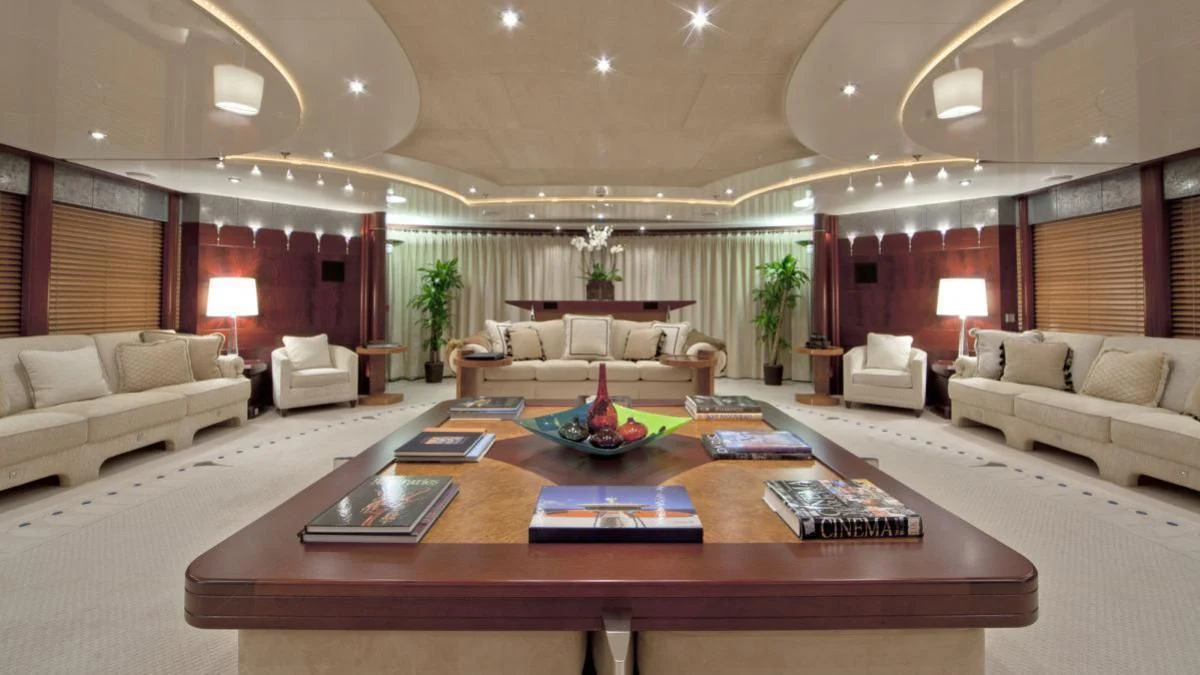 a living room with a table and couches aboard SARAH Yacht for Sale