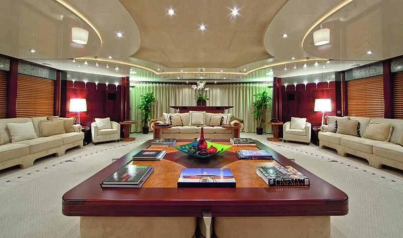 a living room with a table and couches aboard SARAH Yacht for Sale