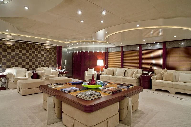 a living room with a table and couches aboard SARAH Yacht for Sale