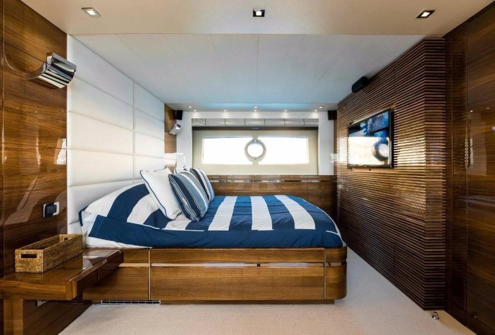 a bedroom with a bed and a tv aboard YINWA Yacht for Sale