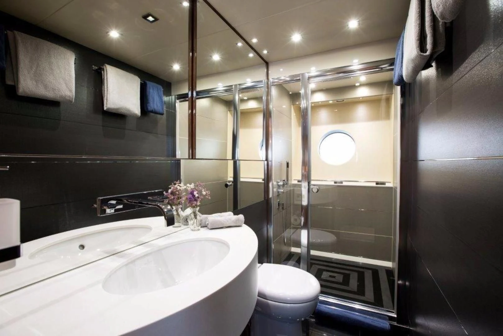 a bathroom with a glass shower aboard YINWA Yacht for Sale
