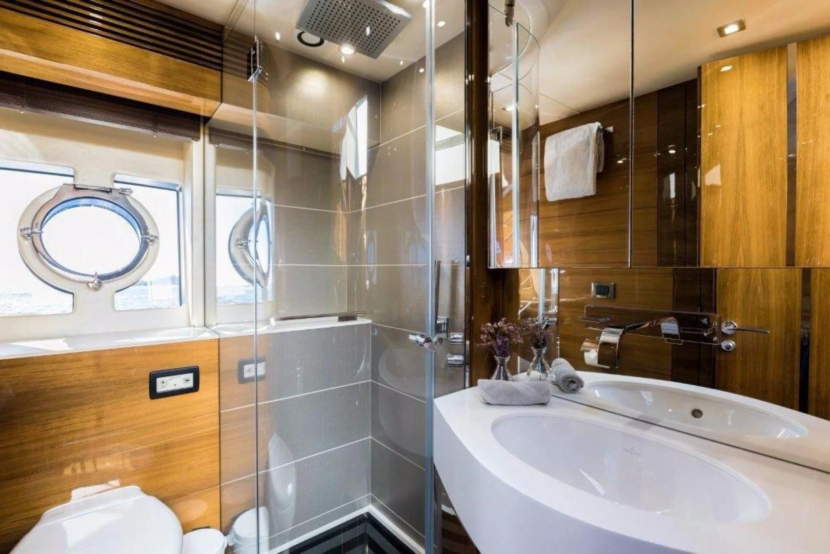 a bathroom with a glass shower aboard YINWA Yacht for Sale