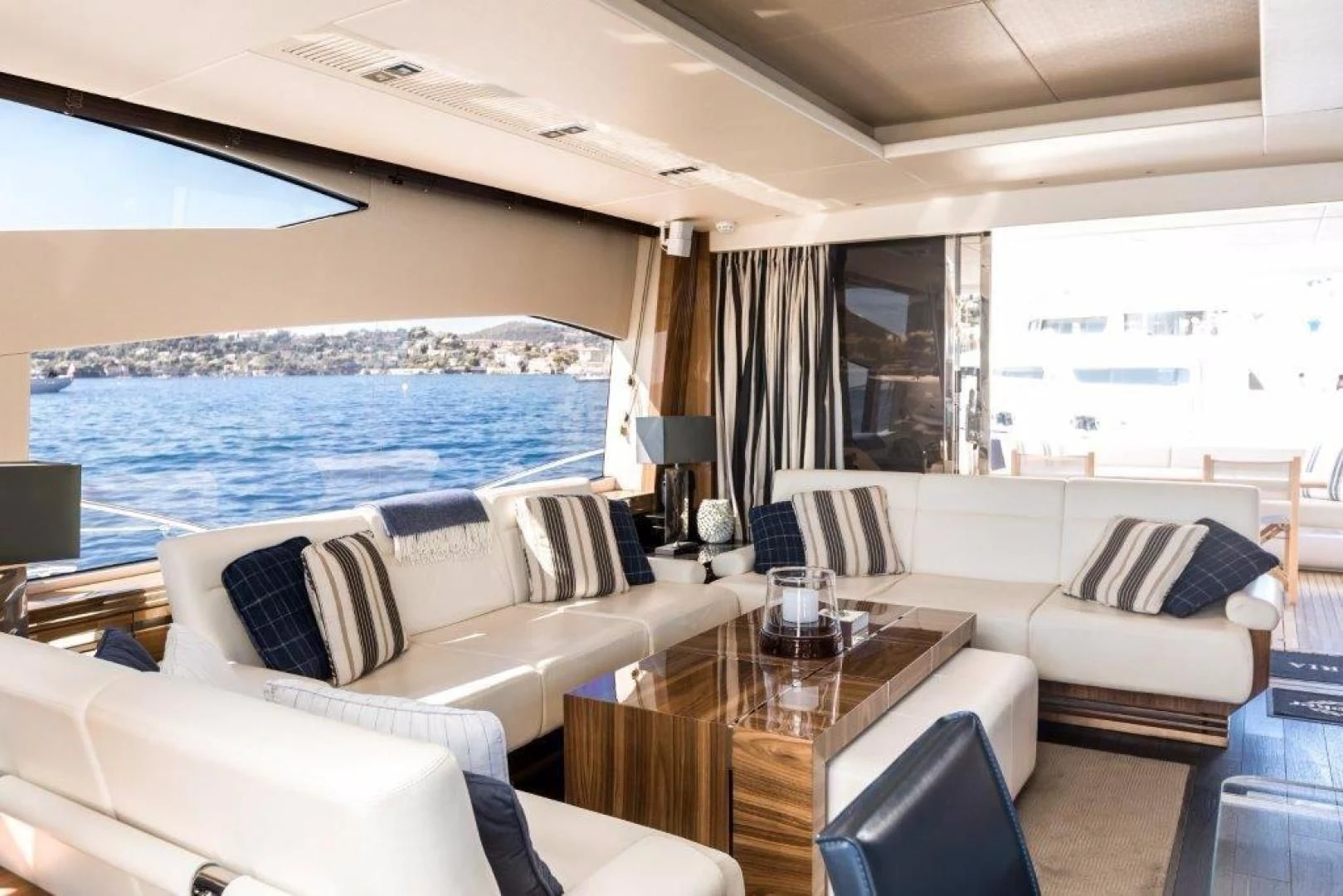 a living room with a large cruise ship in the background aboard YINWA Yacht for Sale