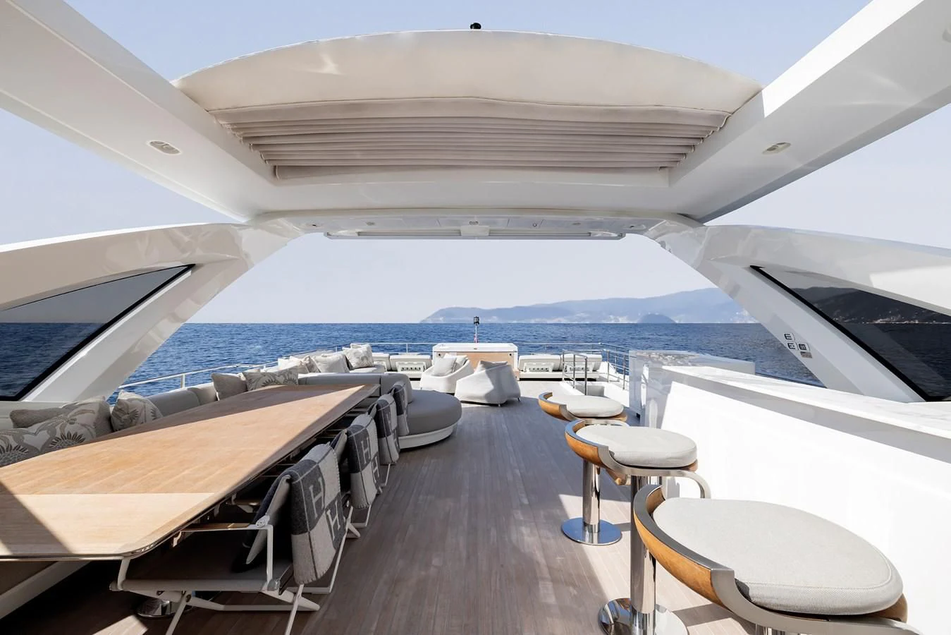 a deck with chairs and tables on it aboard AZIMUT GRANDE 32M Yacht for Sale