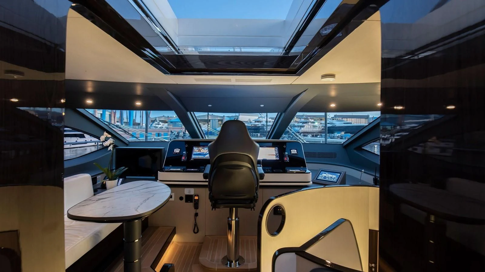 a room with a chair and a table with a chair aboard AZIMUT GRANDE 32M Yacht for Sale