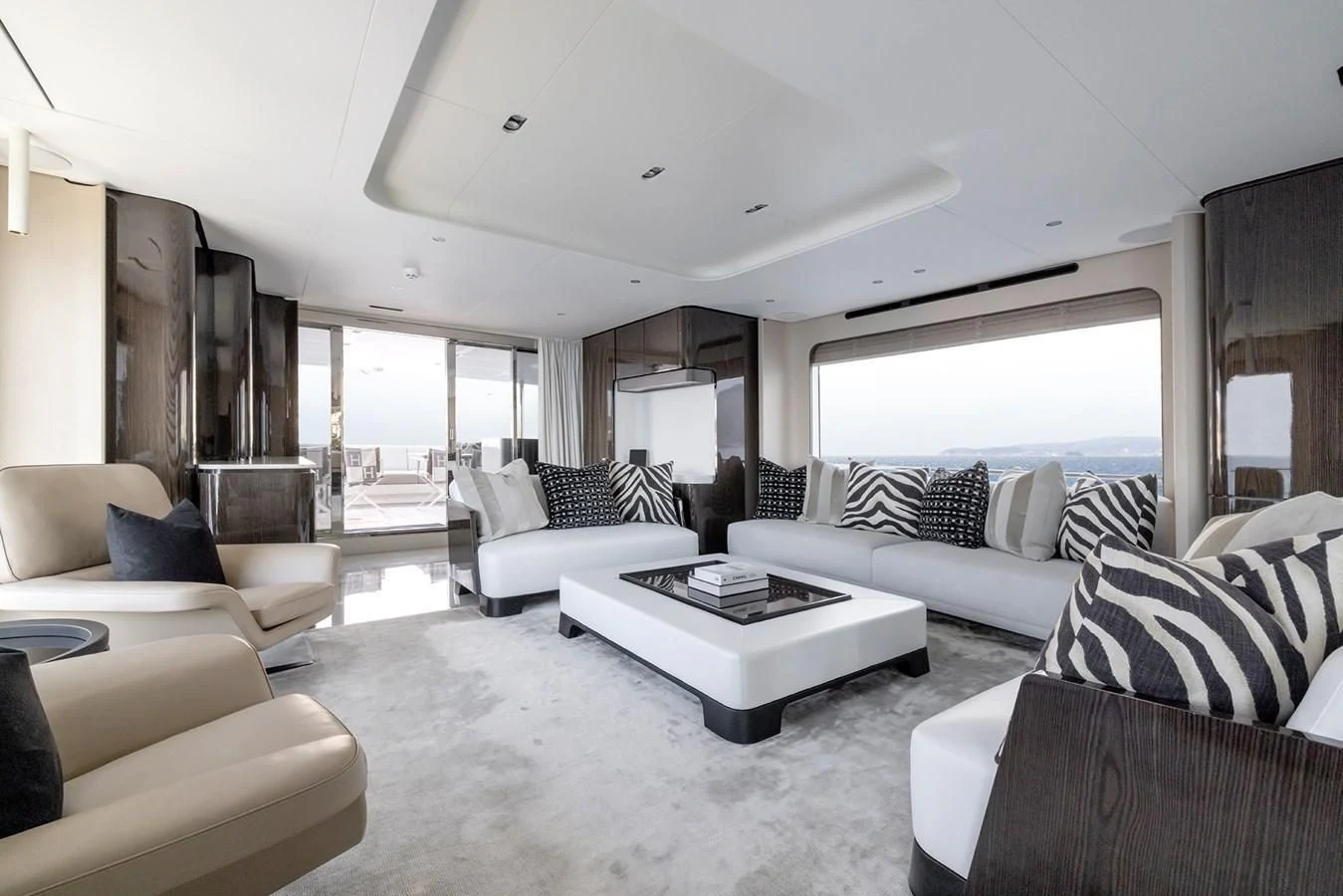 a living room with white furniture aboard AZIMUT GRANDE 32M Yacht for Sale