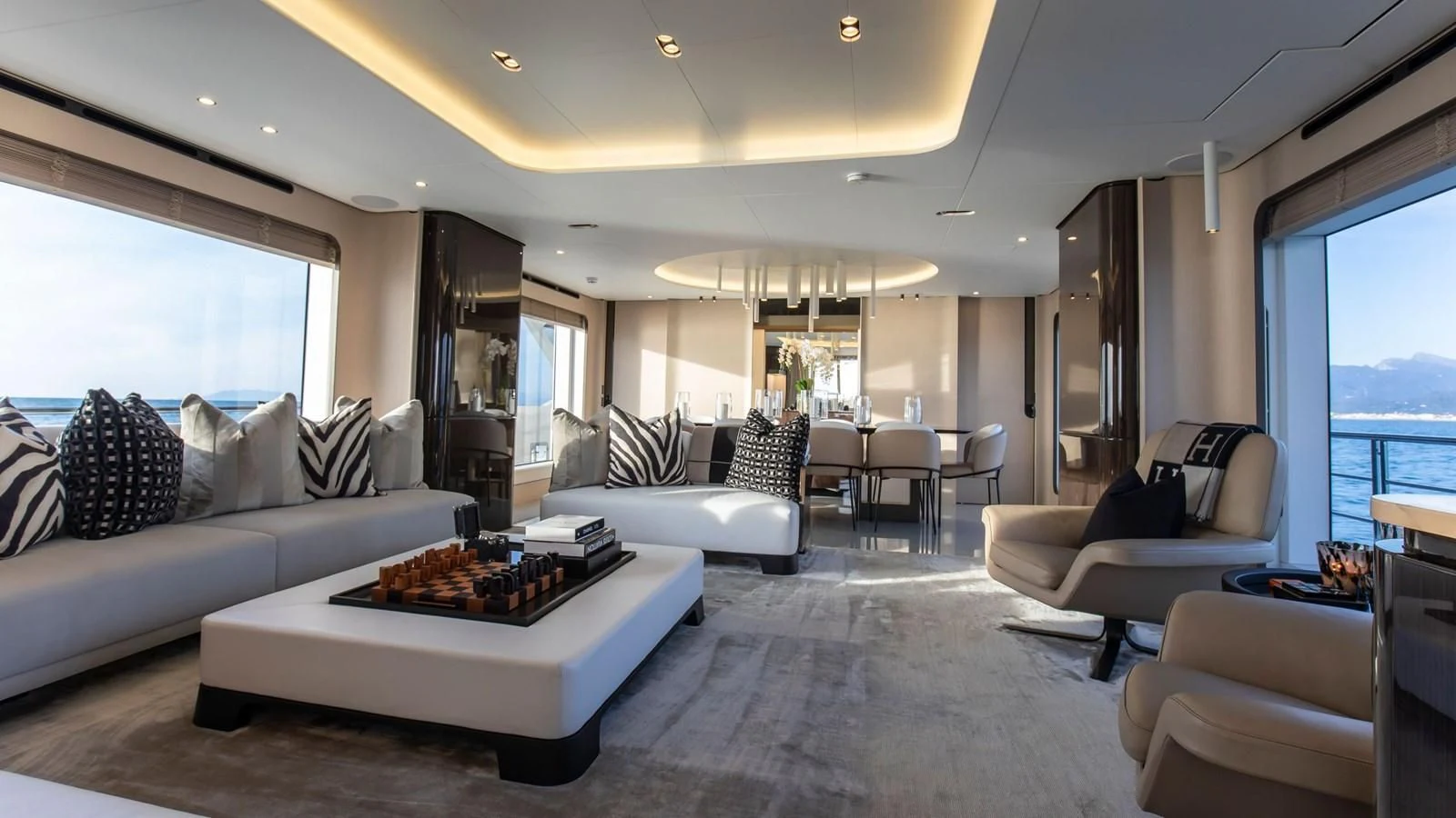 a living room with a large white couch and a large window aboard AZIMUT GRANDE 32M Yacht for Sale