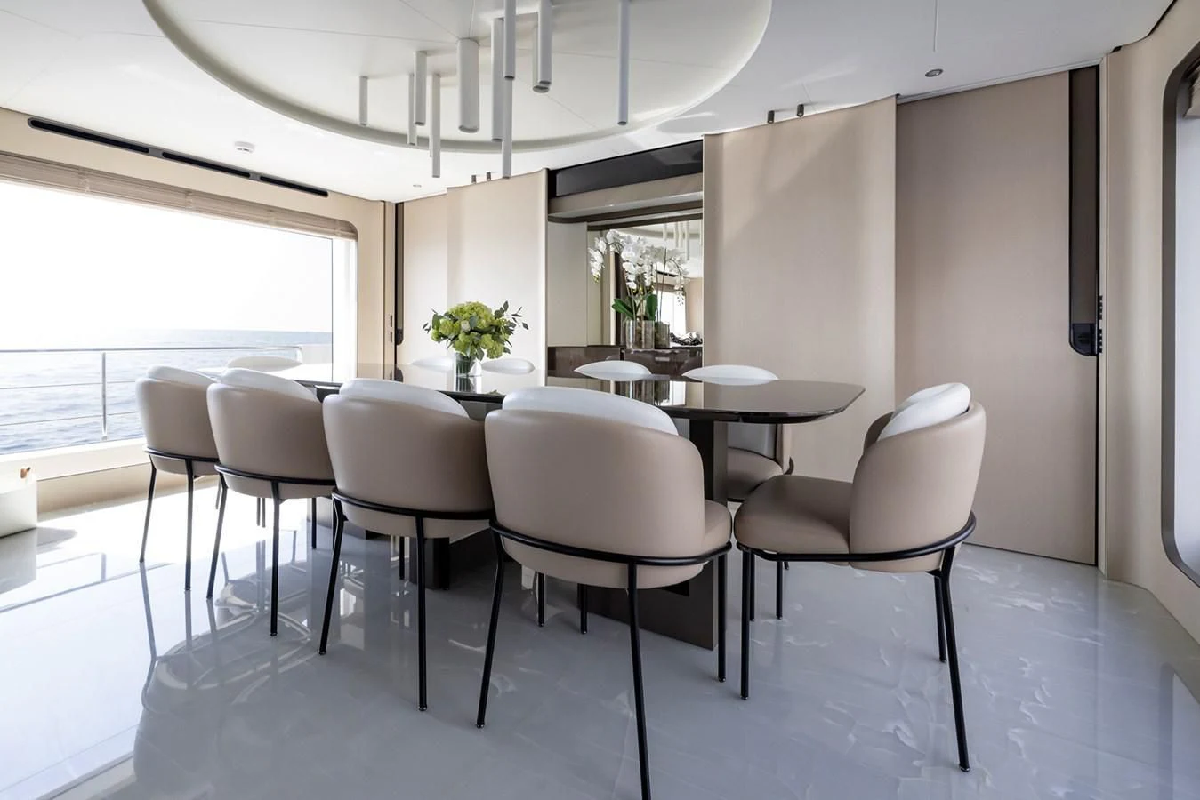 a room with white chairs and a table with white chairs aboard AZIMUT GRANDE 32M Yacht for Sale