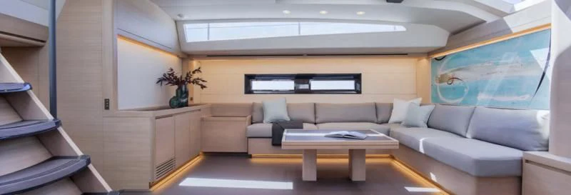a living room with a couch and a table aboard AMMONITE Yacht for Sale