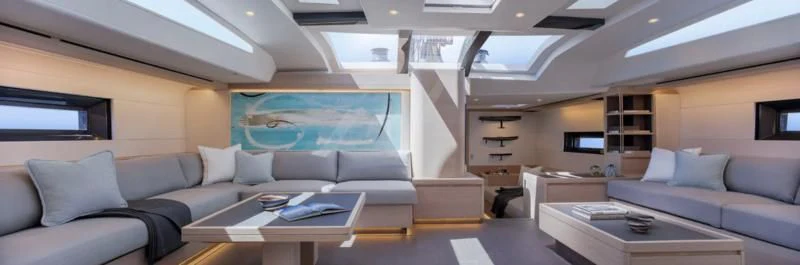 a room with a couch and a table aboard AMMONITE Yacht for Sale