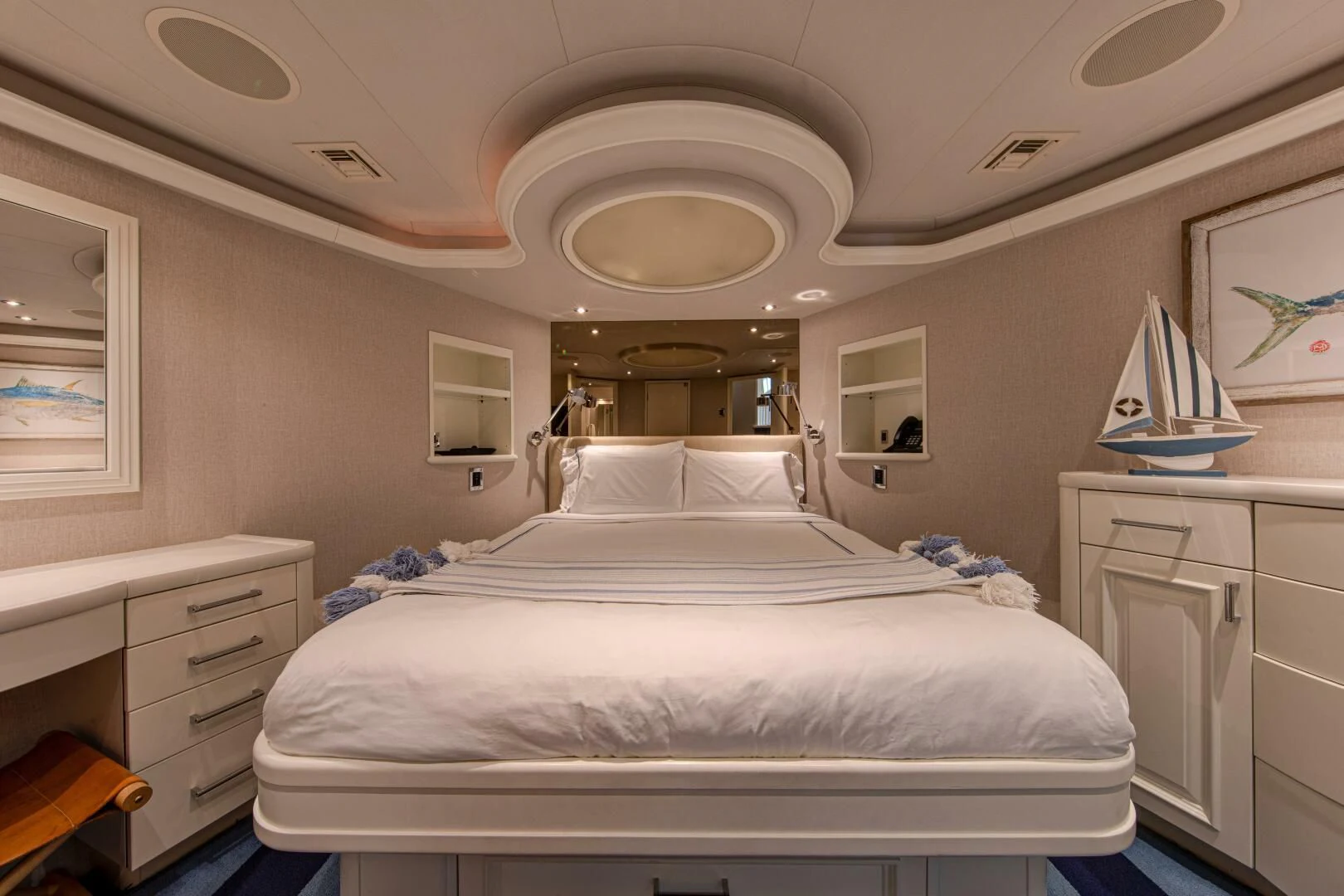 a bedroom with a bed and a dresser aboard LIBERTAS Yacht for Sale