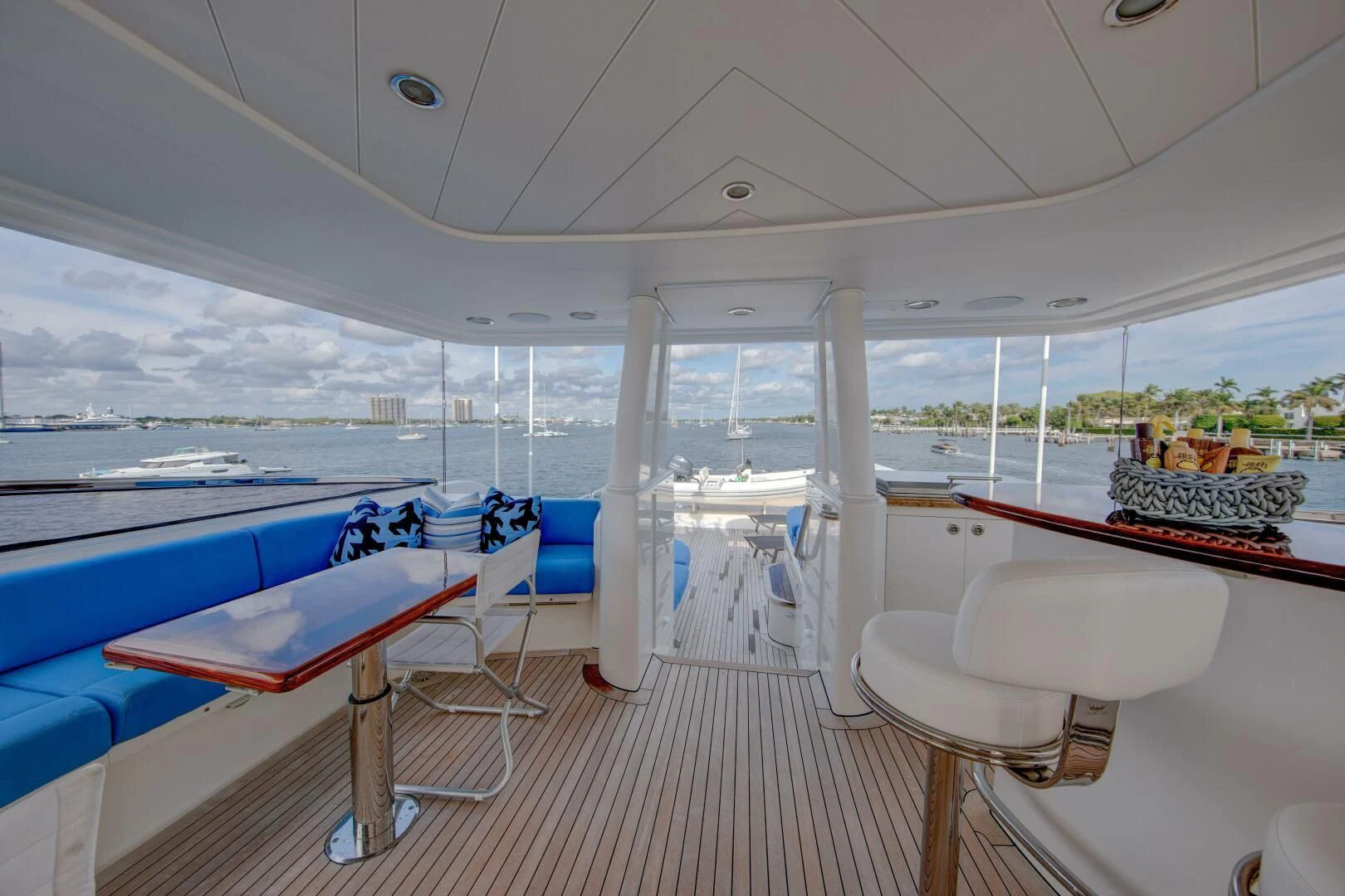 a boat with a deck and chairs aboard LIBERTAS Yacht for Sale