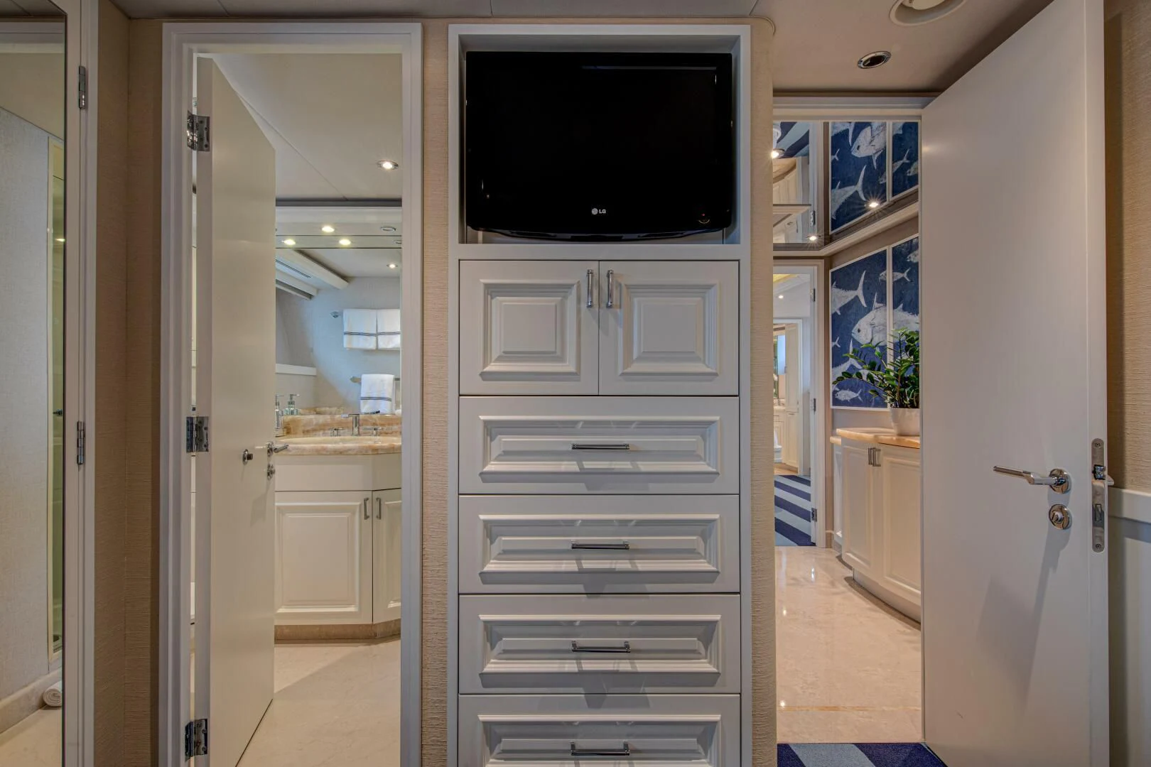 a white bathroom with a flat screen television and a white door aboard LIBERTAS Yacht for Sale